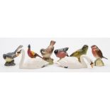 A Royal Worcester Porcelain model of a Sparrow, together with a group of seven Beswick birds:.