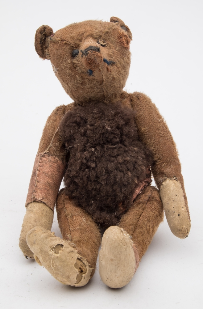 An early 20th century Steiff blonde plush bear:, with button to ear and boot button eyes,