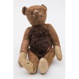An early 20th century Steiff blonde plush bear:, with button to ear and boot button eyes,