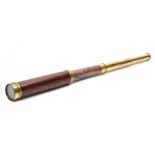 A mahogany and brass three draw telescope by Dollond, London:, 73cm extended.