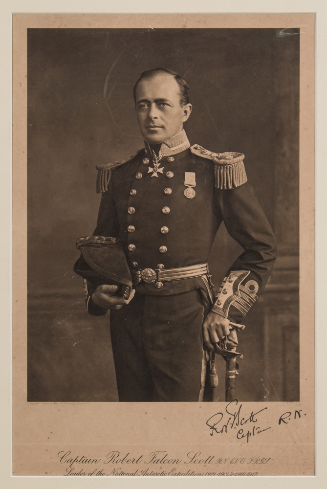 A monochrome lithograph portrait of Captain Robert Falcon Scott in Naval uniform:,