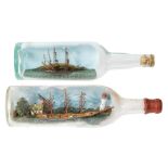 Two early 20th century ships in bottles:, one of a three masted clipper passing a lighthouse,