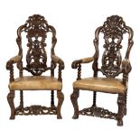 A pair of 19th Century carved oak open armchairs in the Baroque taste:,