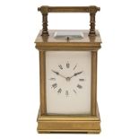 A Victorian brass carriage clock: the eight-day duration movement having a platform lever