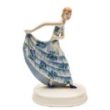 A Goldscheider figure of a dancer: modelled after the original by Stephan Dakon lifting her blue