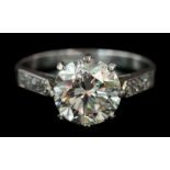 A diamond solitaire ring: the round brilliant-cut diamond approximately 8.4mm diameter x 5.