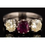 A ruby and yellow diamond three-stone ring: with central cushion-shaped ruby approximately 1.