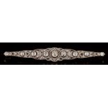 An early 20th century platinum-faced gold and diamond mounted bar brooch: of pierced elliptical