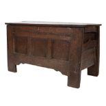 An 18th Century oak rectangular coffer:, with a plain hinged top and triple moulded panel front,
