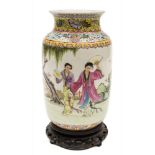 A Chinese porcelain vase: decorated in the famille rose palette with two female figures holding