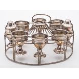 An old Sheffield plate egg cup stand: the oval-shaped cage with reeded decoration,
