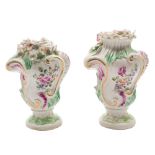A pair of Derby pedestal vases: of rococo bombe form, each moulded with scrollwork,
