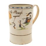 A Pratt creamware cylindrical mug: inscribed 'God speed the Plough' and painted with a large sheaf
