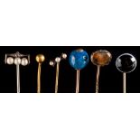 A collection of sixty-seven stick pins: with various gem-set motifs including a gold nugget,