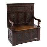 A carved oak box settle:,