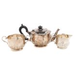 A George V hammered silver three-piece tea service, maker Goldsmiths & Silversmiths Co Ltd, London,