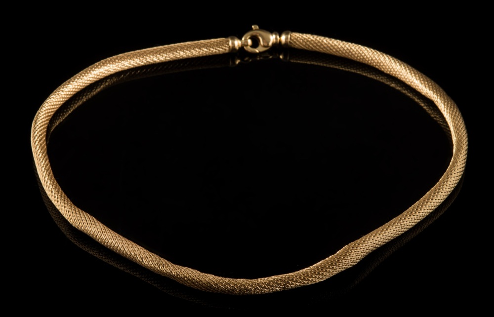 A mesh-link necklace: of tubular mesh snake-like linking with 'parrot beak' clasp stamped '750',