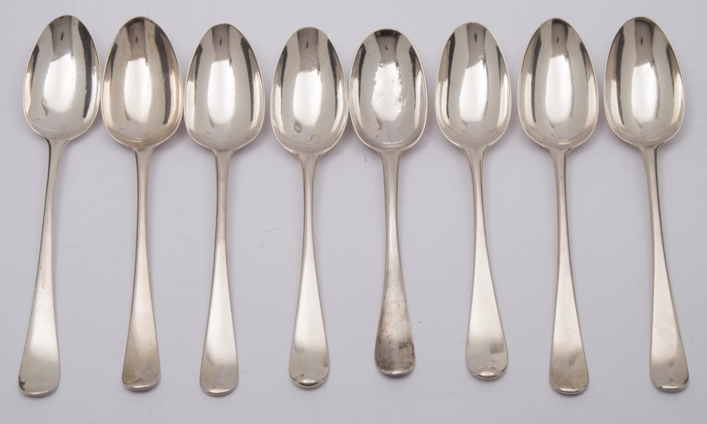 Eight Georgian silver Hanoverian pattern dessert spoons, marks worn,