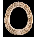 A late 19th century Cantonese carved ivory photograph frame: of oval outline,