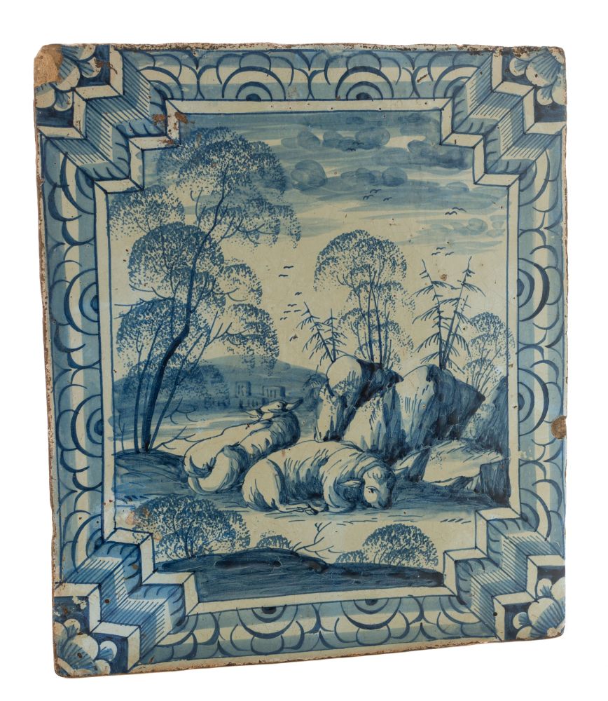 A Continental blue and white tin-glazed stove tile: painted with a ram and ewe in an extensive