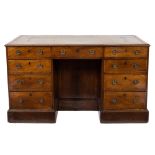 A George III mahogany and inlaid kneehole desk:, bordered with boxwood lines,