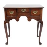 A George II mahogany lowboy:, the rectangular top with rounded corners and a moulded edge,