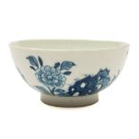 A Lowestoft blue and white waste bowl: painted with pierced rockwork, peony and other floral sprays,
