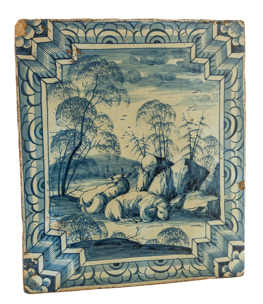 A Continental blue and white tin-glazed stove tile: painted with a ram and ewe in an extensive - Image 2 of 2