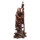 A large Chinese carved hardwood figure of Shou Lao: the smiling Immortal holding a knarled staff