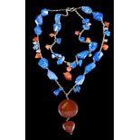 A lapis lazuli and cornelian agate bead necklace: with attached animal motif pendants and