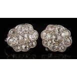 A pair of diamond oval cluster earrings: pave-set with cushion shaped, old-cut diamonds,