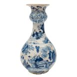 A Dutch blue and white delft garlic-necked bottle vase: painted with oriental figures in landscapes