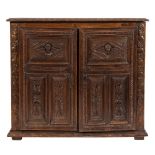 A part 17th Century and later Italian carved oak side cupboard:,