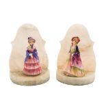 A pair of Royal Doulton bookends: the alabaster mounts set with two figures of girls wearing