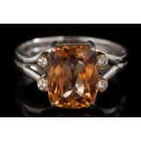 A modern topaz and diamond ring: the cushion shaped topaz approximately 10.7mm long x 8.