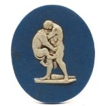 An unusual Enoch Wood blue and white jasperware oval relief plaque: depicting Heracles wrestling