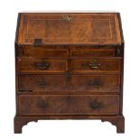 An early 18th Century walnut and feather banded bureau:,