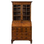 An 18th Century walnut bureau bookcase:, the upper part with a moulded cornice,