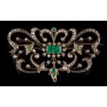 An emerald and rose diamond mounted plaque brooch: of scroll work design,