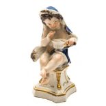 A Meissen figure of a putto emblematic of Winter: wearing a blue fur lined cloak and holding a pan
