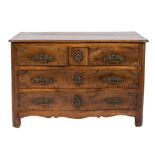 An 18th Century French Provincial walnut serpentine fronted commode:, the top with a moulded edge,