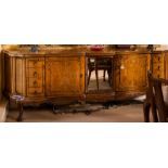 A carved and burr walnut veneer serpentine fronted sideboard of large size:, with rocaille,