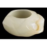 A Chinese carved jade brush washer: in the form of a flattened peach with stalk to one side,