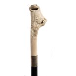 A late 19th century ebonised walking stick: the Japanese carved ivory handle decorated with a toad