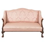 A carved mahogany semi wing frame settee in the Georgian taste:, with a serpentine stuff over back,