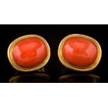 A pair of coral single-stone stud/clip earrings: each cushion shaped coral approximately 16.