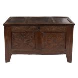 An early 18th Century carved oak rectangular coffer:, with a plain moulded triple panel hinged top,