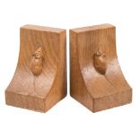 A pair of Robert Thompson (Mouseman) carved oak bookends: of swept square form,