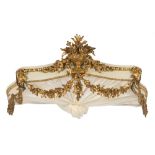 A carved wood and cream and gilt decorated serpentine fronted canopy:,