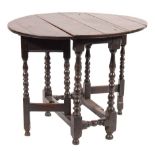 An early 18th Century oak oval gateleg table:, the hinged top on bobbin turned legs,